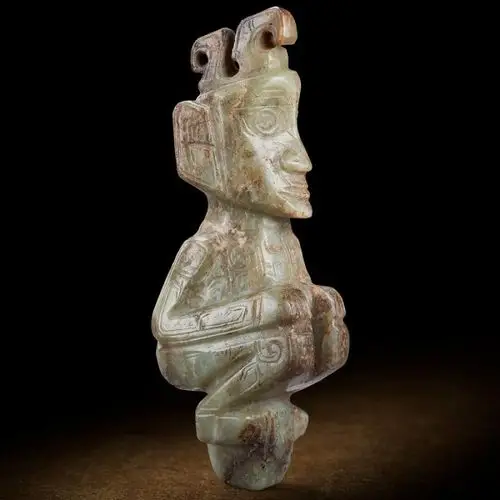 a chinese celadon jade kneeling figure