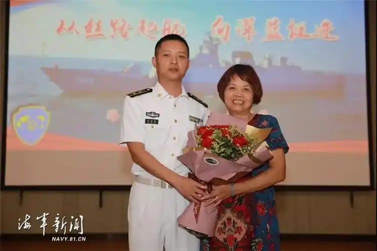 泉州舰舰长沈闽锋在报告会上向母亲林文英献花