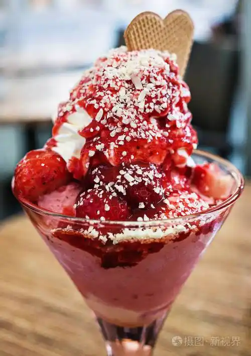 冰淇淋甜点,草莓和鲜奶油在玻璃杯中供应照片-正版商用图片186z8t-摄