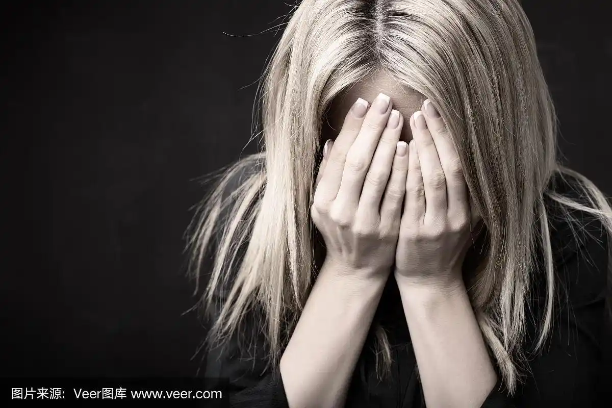 一个女人用手捂着脸的特写