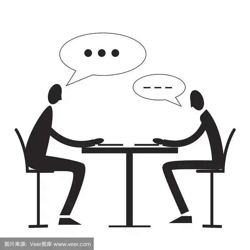 两个人坐在桌子旁交谈.