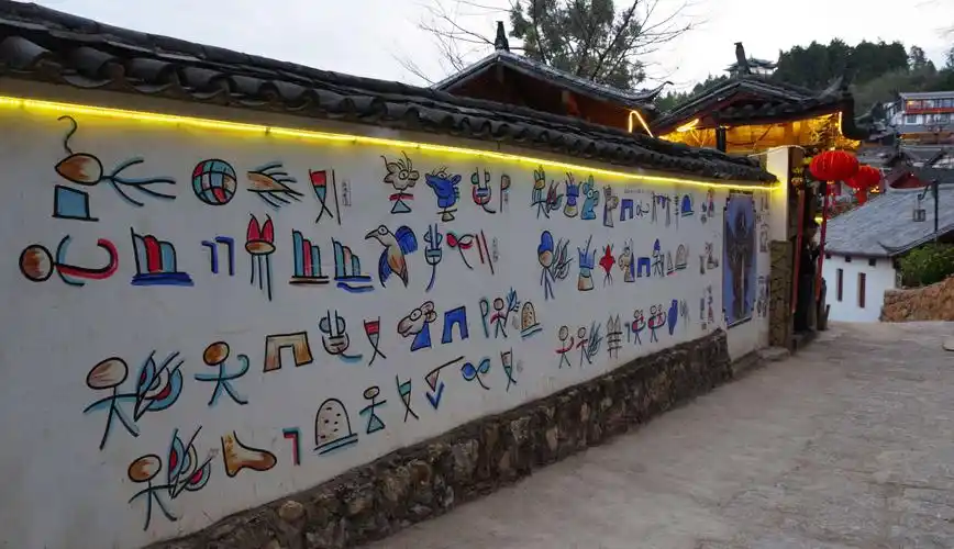 发现一栋围墙上写着有趣的纳西族活的甲骨文,古象形文字"东巴文"