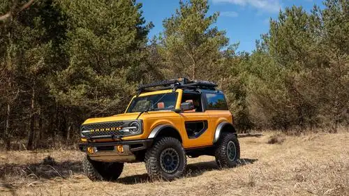2021 ford bronco two-door yellow driving off-road through forest