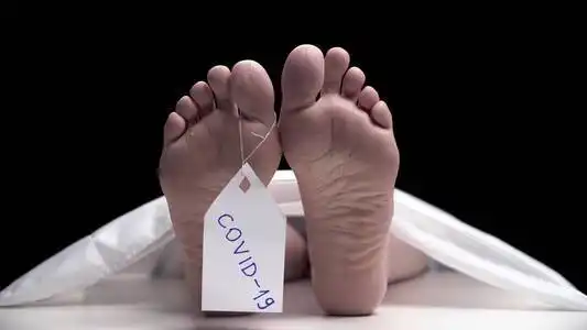 脚谋杀白色标牌covid-19挂在脚上.