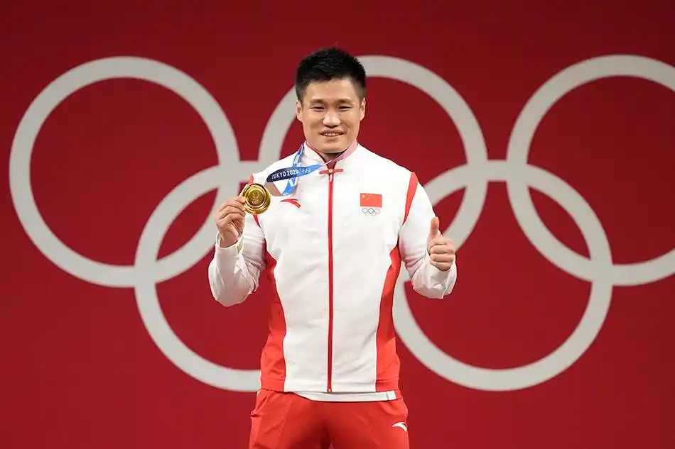 吕小军站上领奖台竖起大拇指,笑容满面展示金牌.