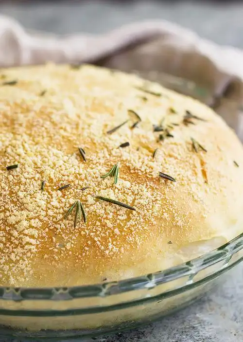 close up of a round loaf of rosemary parmesan bread.