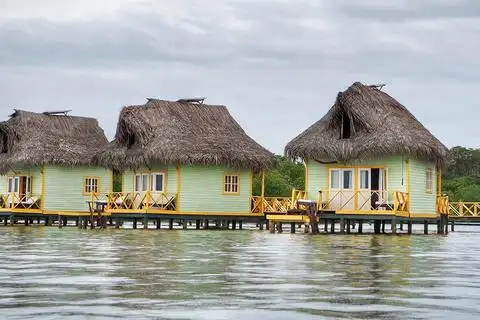 thatch-roof buildings on the water in panama
