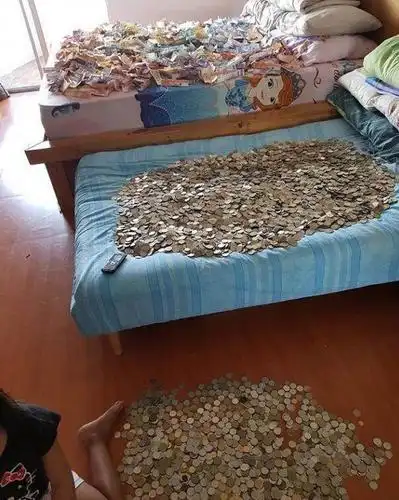 国外小女孩将零花钱存进透明玻璃柜里,一年后零花钱堆满整个床