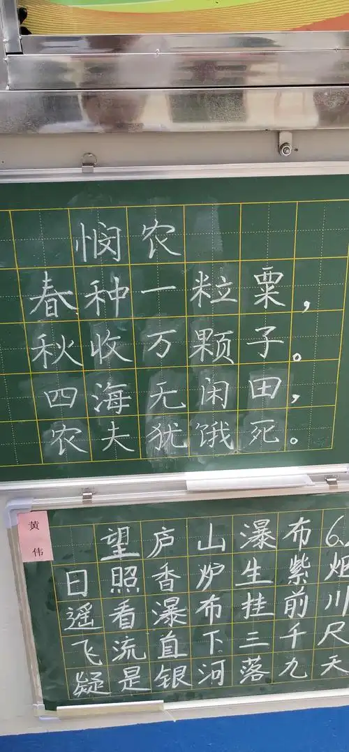 书法老师在黑板上书写诗句供学员临摹.