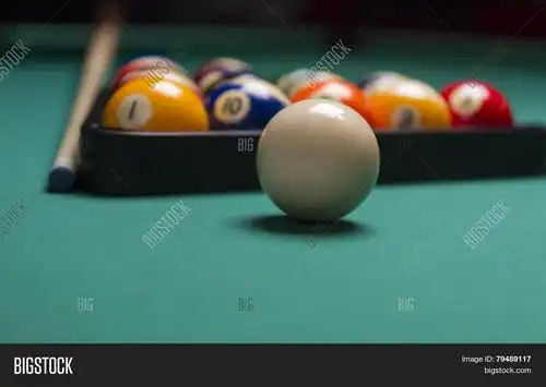 billiard balls arranged in a triangle;selective focus on cue