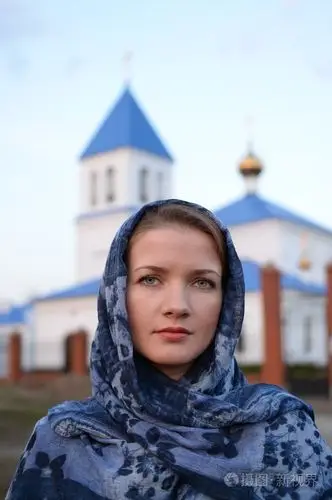 一个女孩斯拉夫俄罗斯出现在教会的背景上的一条围巾