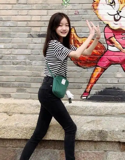 这组照片中纪姿含一身的穿搭看起来也很简约,上衣穿了黑白条纹的t恤