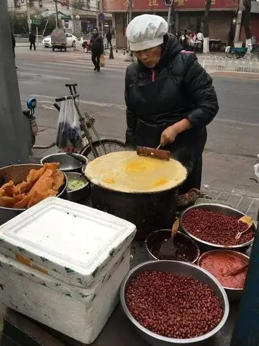 一个无证经营的小摊,在路边一卖30年,竟然还让人民日报为它狂打call?