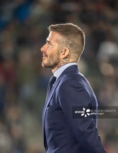 贝克汉姆一袭西装奔跑在足球场,勾勒出倒三角,身材比例让人羡慕