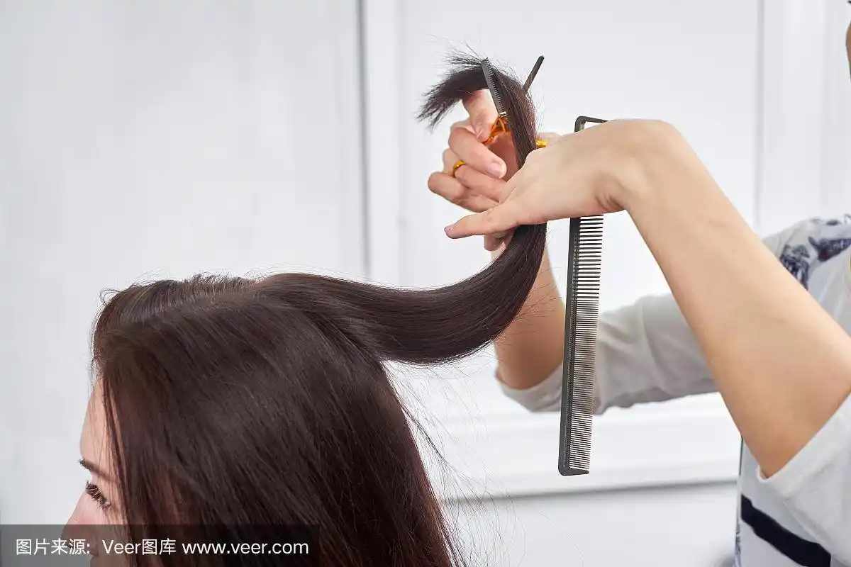 一个理发师剪一个女人的头发的特写.