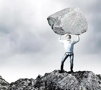 家伙举石头年轻 i>强 /i>壮的男人,拿着巨大的石头,头顶
