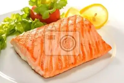 grilled salmon with vegetables on white plate