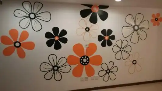 在墙面上根据图案大致的形状贴上胶纸,这是为了在上面画图案用的