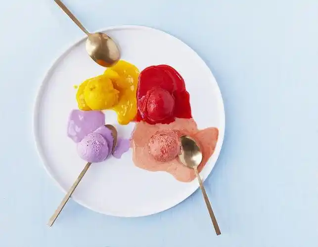 overhead view of melting colourful scooped gelato ice cream with