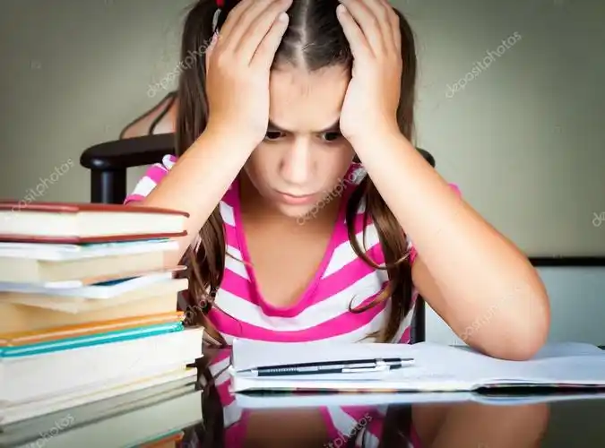 angry and tired schoolgirl studying