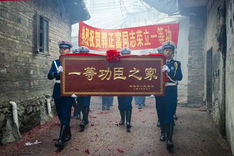 甘孜州消防救援支队联合贵州省都匀市送牌匾到一等功臣郭正富家.