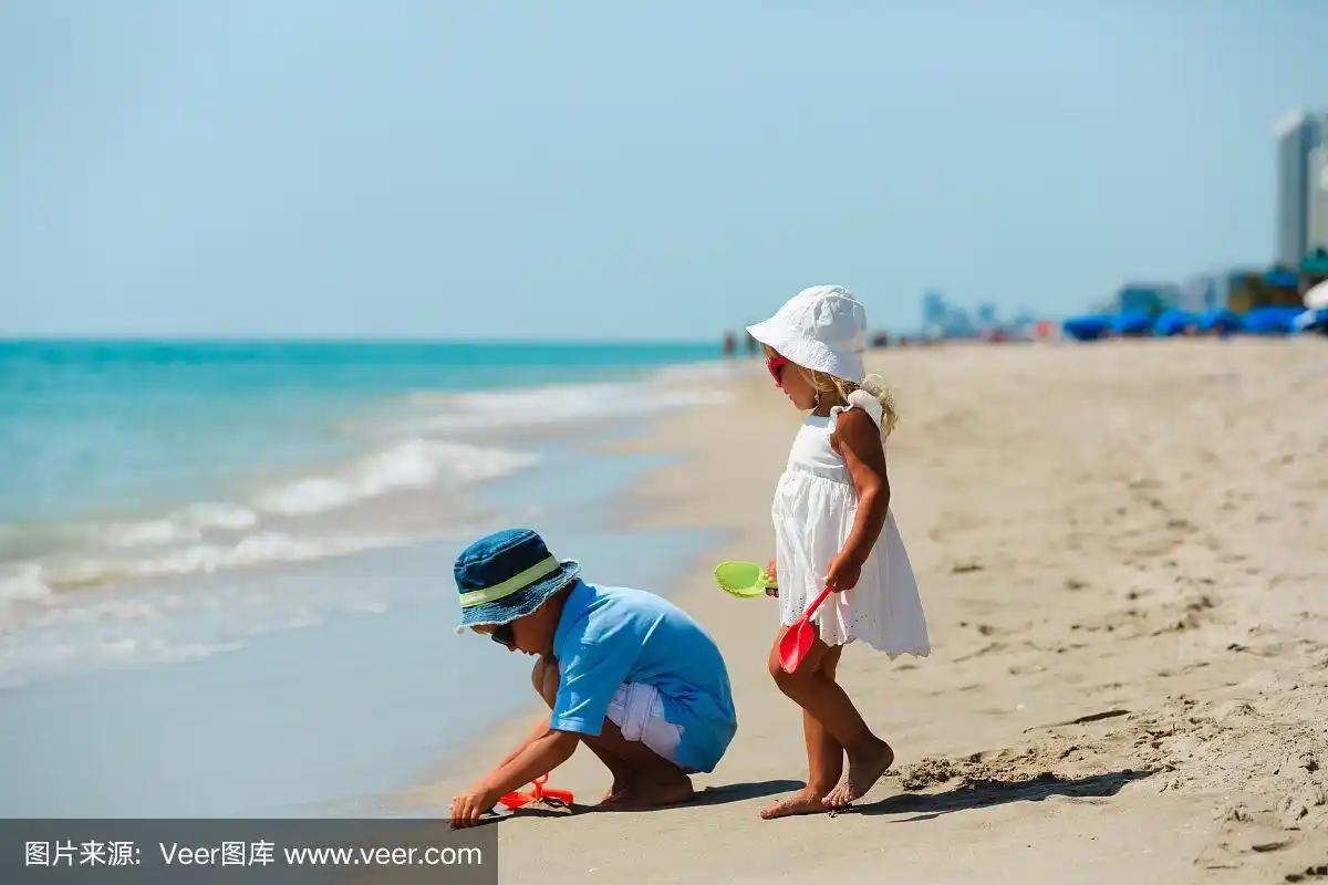 孩子们在夏天的海滩上玩沙子