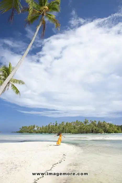 pacific islander woman standing on tropical beach