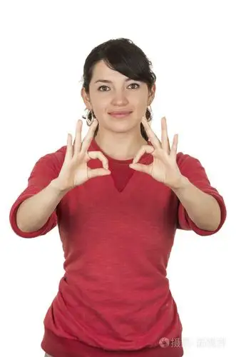 年轻漂亮的女孩穿着红顶构成好的手势