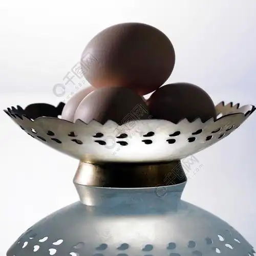 放在金属板上的四个鸡蛋的侧视图