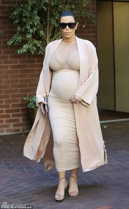 与普通孕妇不同的是,卡戴珊依然穿着紧身衣,夸张的线条一览无余