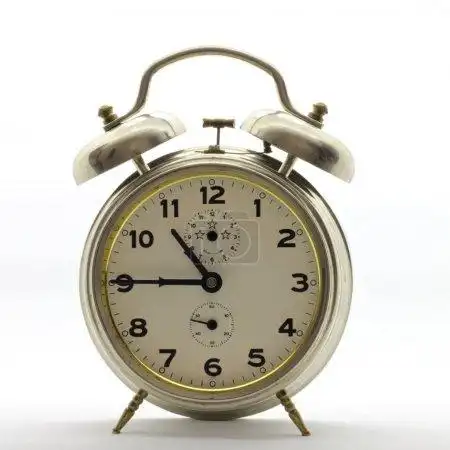 old-style alarm clock, metal, its quarter to eleven.
