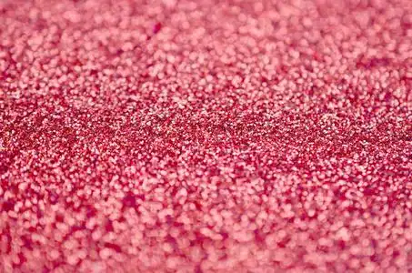 珊瑚红装饰亮片.背景图像中有来自小元素的闪亮的bokeh光照片