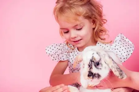 漂亮女孩子和宠物一起庆祝复活节,孩子在柳条上画彩蛋篮子.