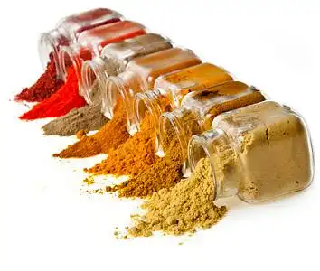 powder colorful spices in glass jar on white
