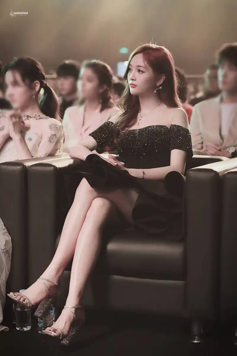 吴宣仪穿黑色露肩礼服亮相活动坐在台下,皮肤白皙气质优雅