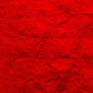 皱巴巴的牛皮纸的纹理是红色的.再生纸背景.墙纸的创意和设计.照片