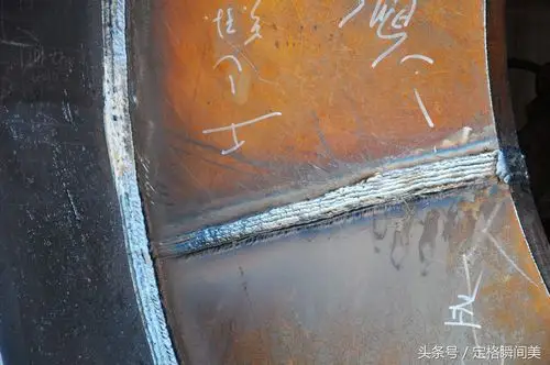 图为:一名电焊工人完成焊接焊口.