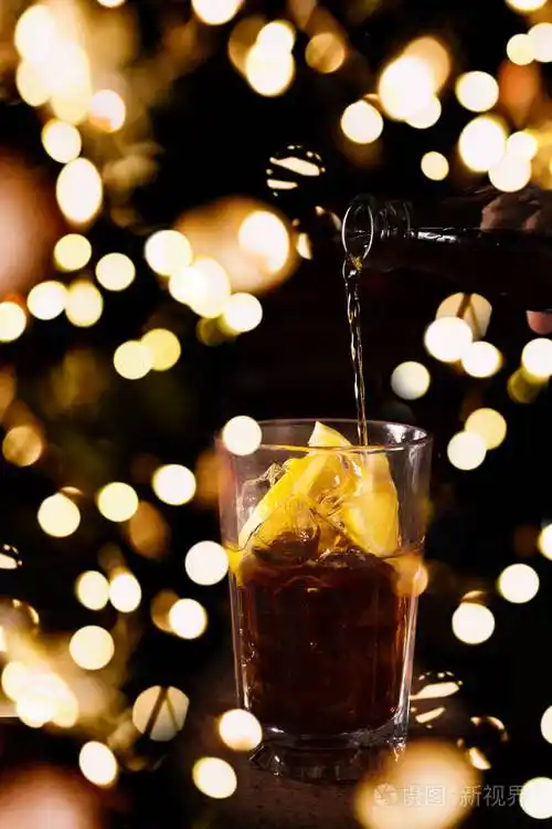 酒吧男招待在一个高高的酒杯里准备古巴自由鸡尾酒