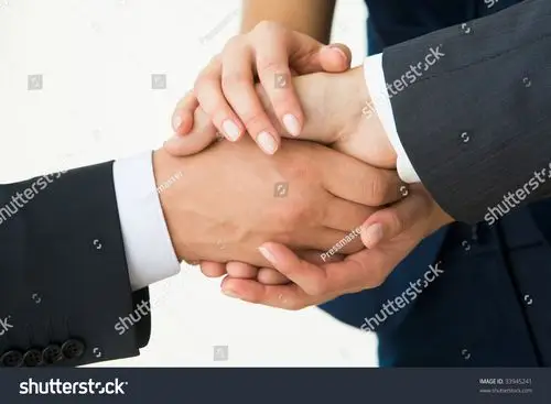 握手的照片,白色背景惊人的交易后的业务合作伙伴