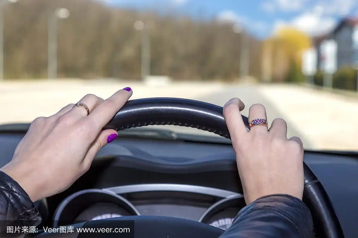 女司机的手放在方向盘上