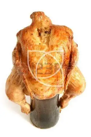 marinated and roasted chicken on a beer bottle on a white back