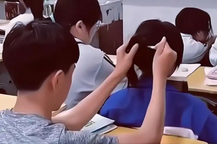 整个拍视频的过程中男生摆弄女同学的头发,女生也没有反抗,应该是关系