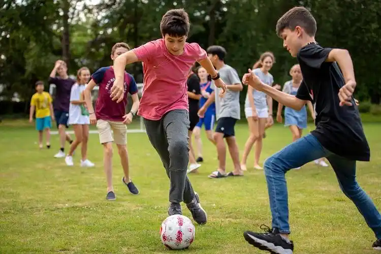 junior summer students playing football