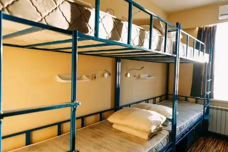 早上在宿舍卧室里,有干净的白色学生床照片