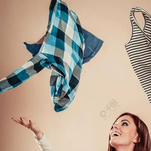 快乐的女孩在空中扔五颜六色的衣服.