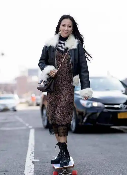 李纯短发造型走机场,毛领皮夹克亮得发光,拎串珠包有童心_皮衣_黑色