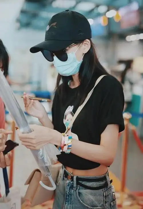 肚脐钉搭配黑色细皮带和破洞牛仔裤,仿佛是从嘻哈世界中走出来的女