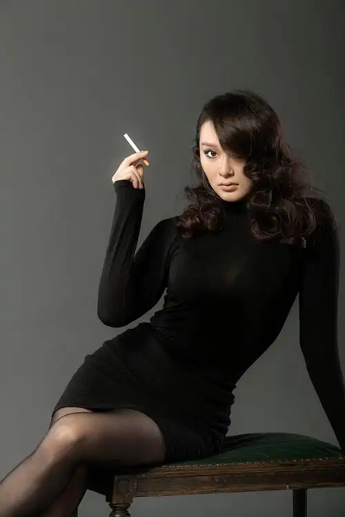 坐在凳子上吸烟的年轻女人