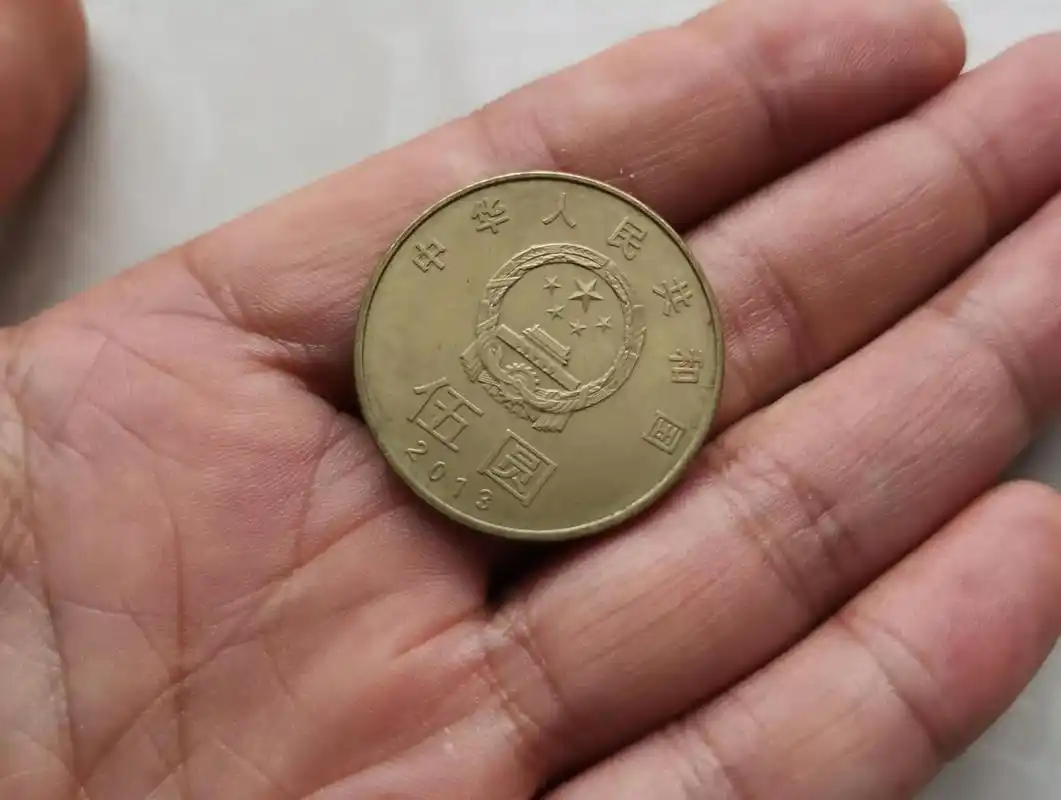 今天从家里翻出一枚面值5元的硬币,拿到菜市场里准备买几斤土豆,付款