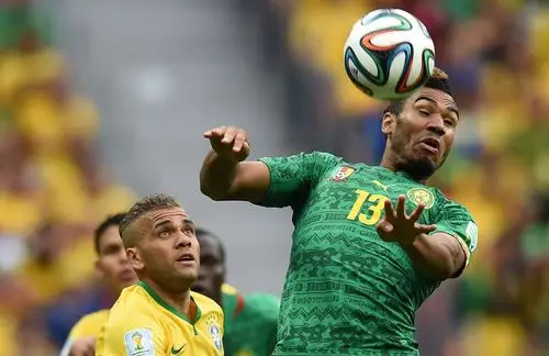 cameroons forward eric maxim choupo-moting (r) heads the ball